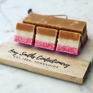 Fudge Ice. Layers of plain & raspberry flavour coconut ice topped with creamy fudge.