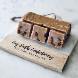 Rum & Raisin Fudge. Our classic creamy fudge bar with raisins & rum flavour swirled through.