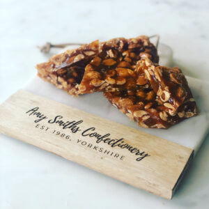 Peanut Brittle. Whole roasted peanuts mixed in our signature toffee sauce.